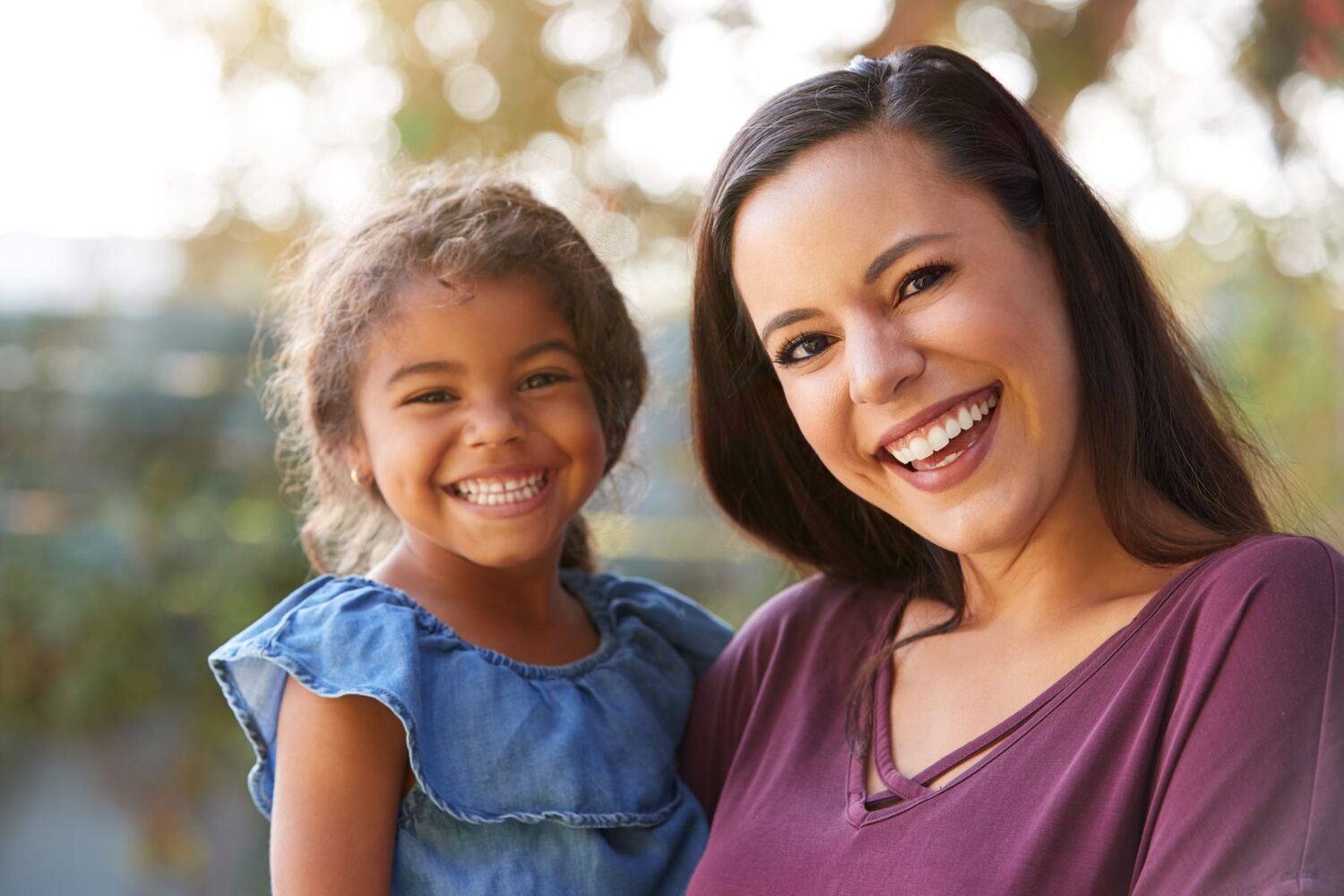 Woman holding child happy
