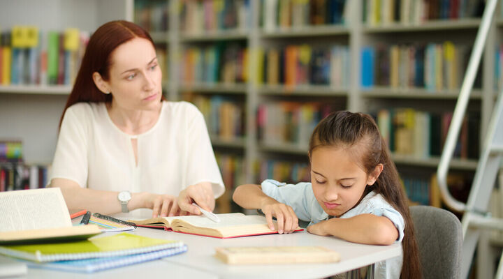 Woman looking at girl refusing to study