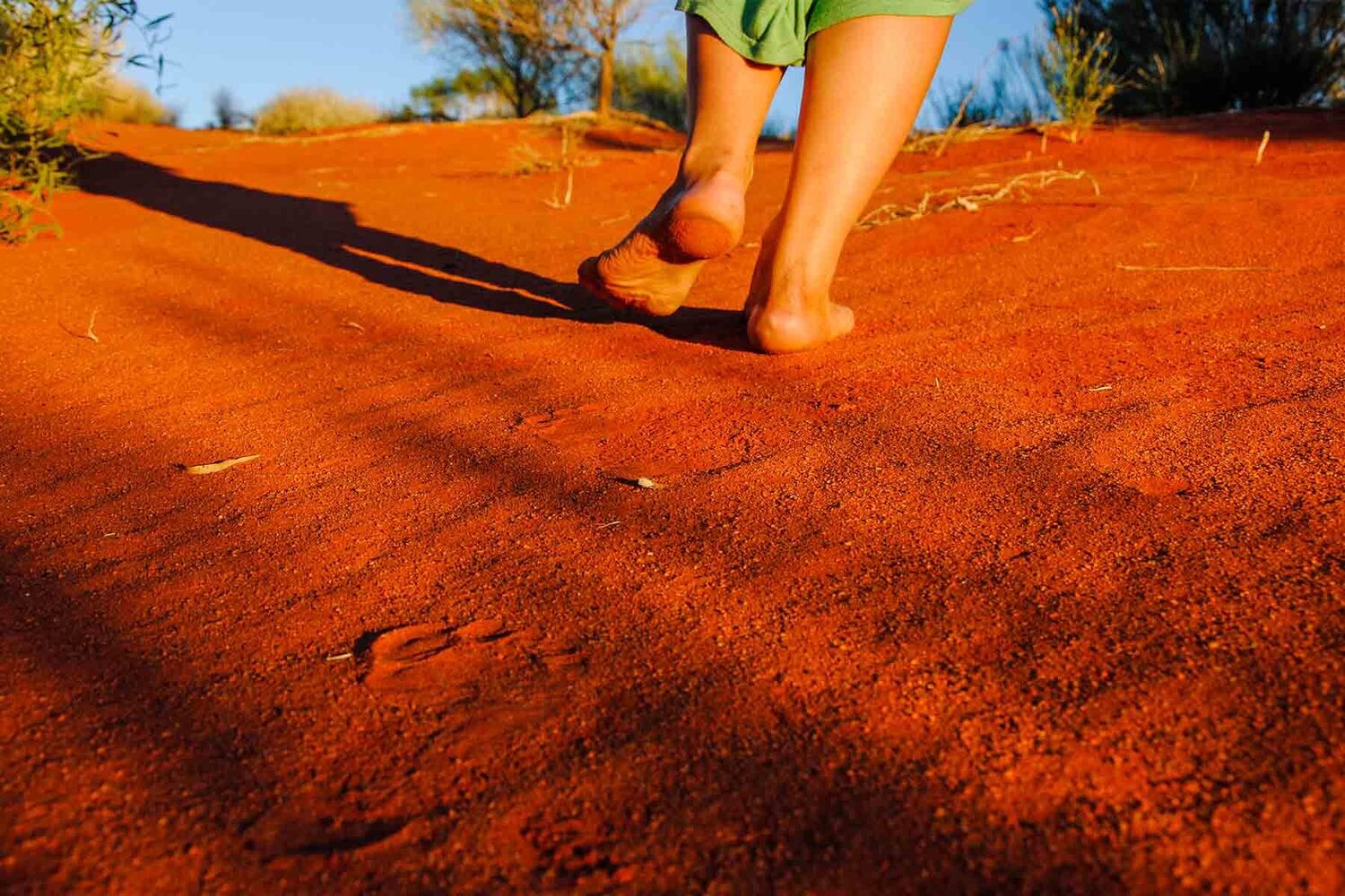 Aboriginal Woman Walking On Red Earth