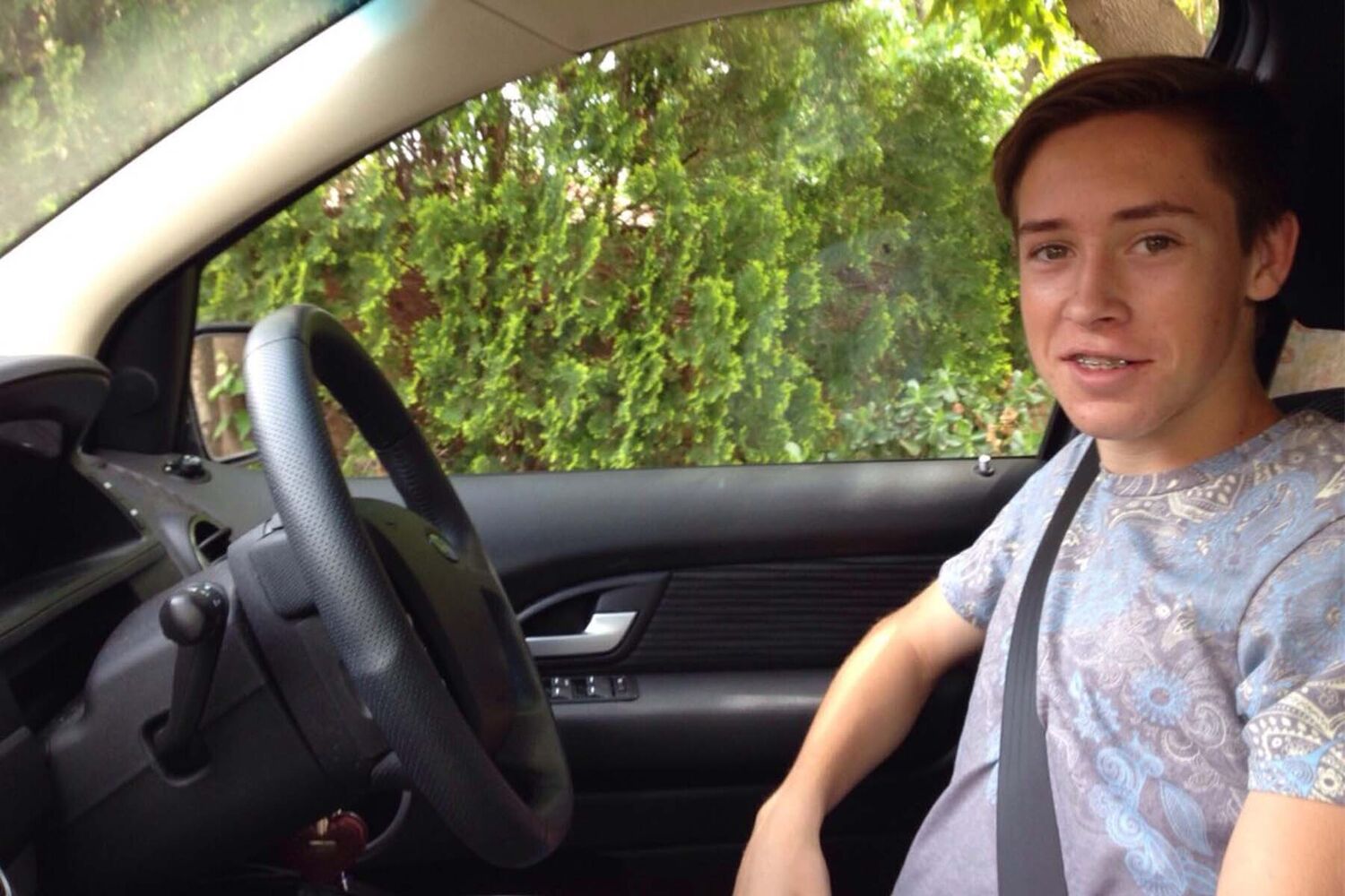 Teenage Boy Sitting In Drivers Seat Learning To Drive