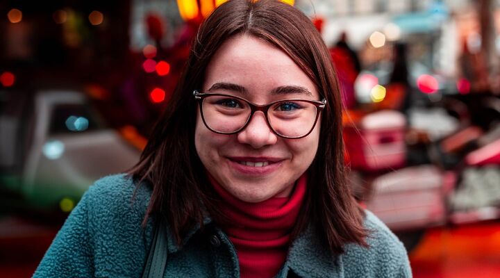 Teen wearing glasses and red turtleneck